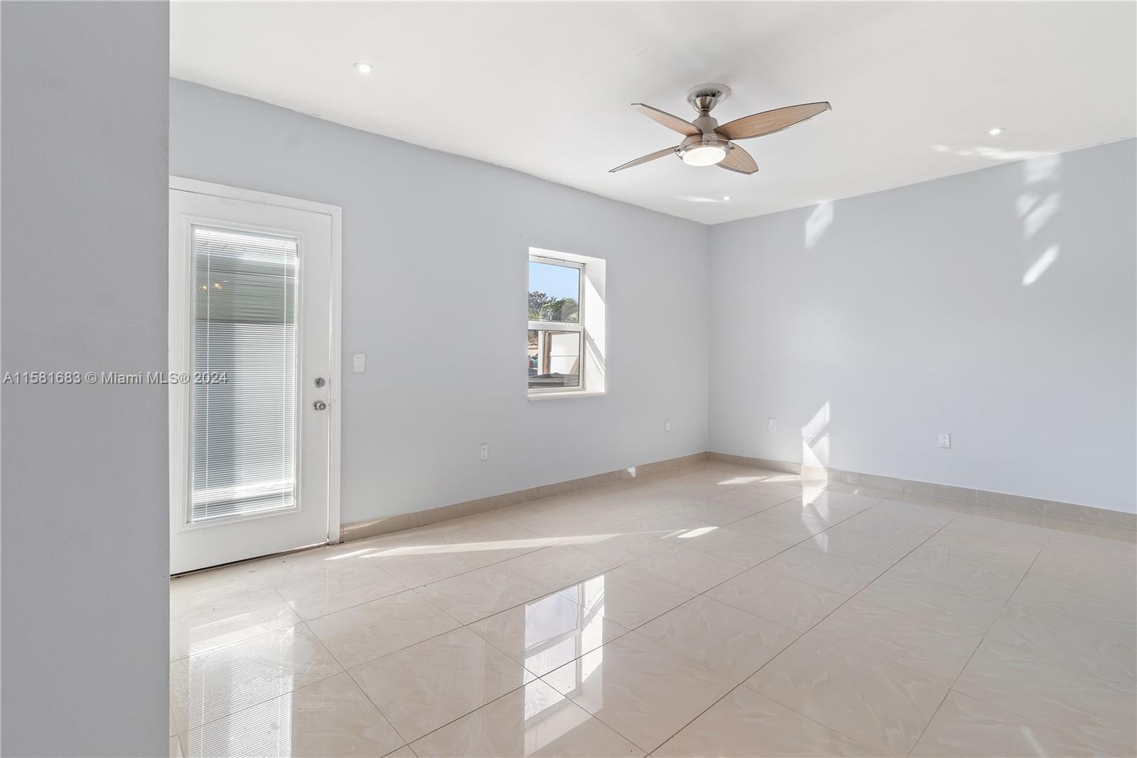10680 Ember Street Boca Raton, FL 33428 - Photo 8 of 19 a view of an empty room with a window