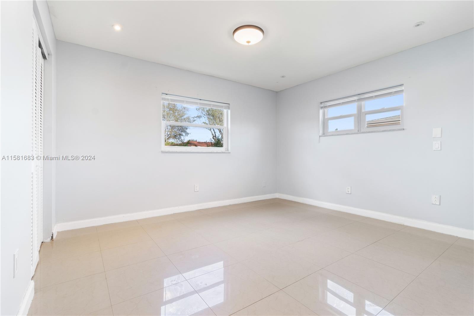 10680 Ember Street Boca Raton, FL 33428 - Photo 9 of 19 an empty room with a window