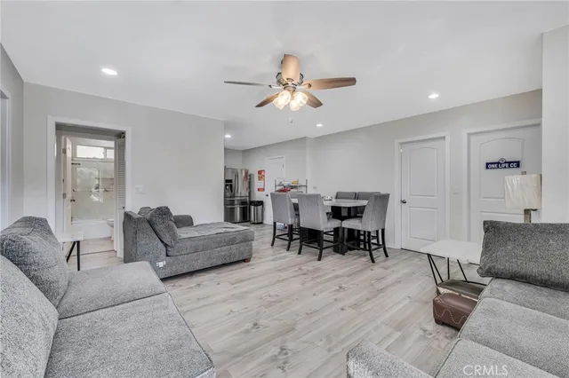 a living room with furniture and kitchen view