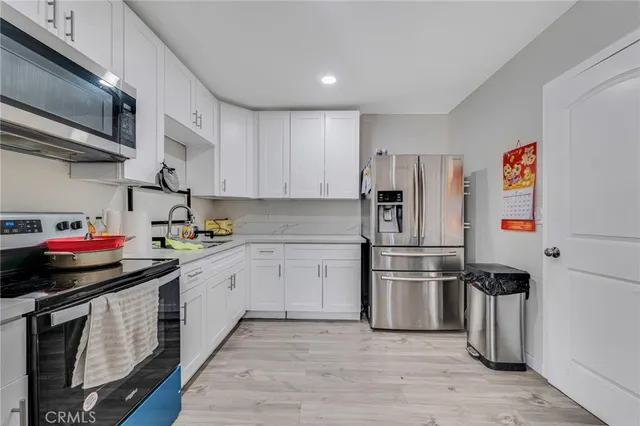 a kitchen with stainless steel appliances granite countertop a sink and a stove