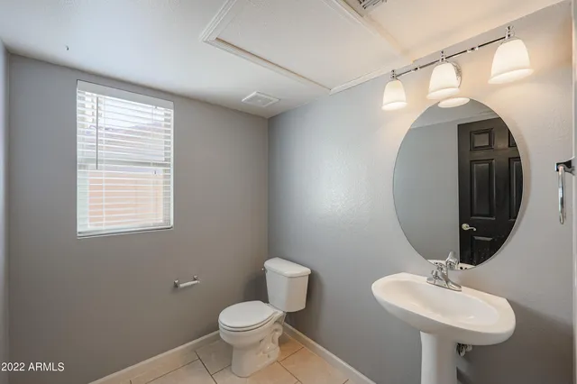 a kitchen with a sink a stove cabinets and a window