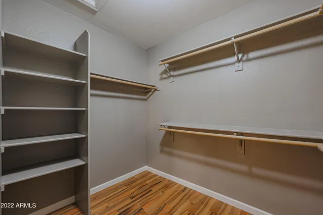 a view of a room with a ceiling fan and closet
