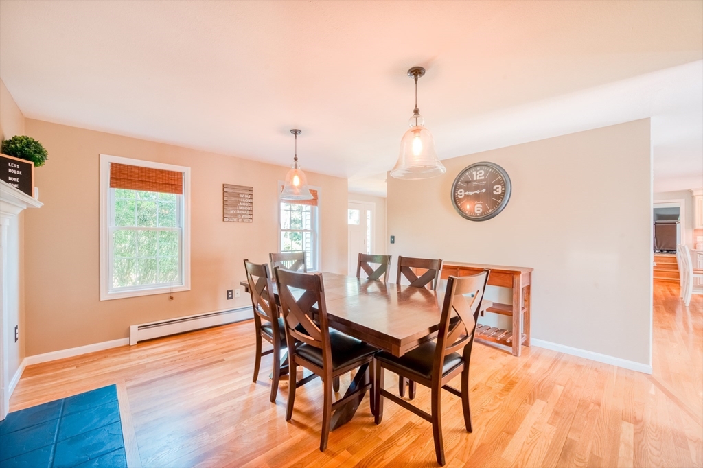 46 Brookline Street Pepperell, MA 01463 - Photo 11 of 41 a view of a dining room and livingroom with furniture wooden floor and a large window