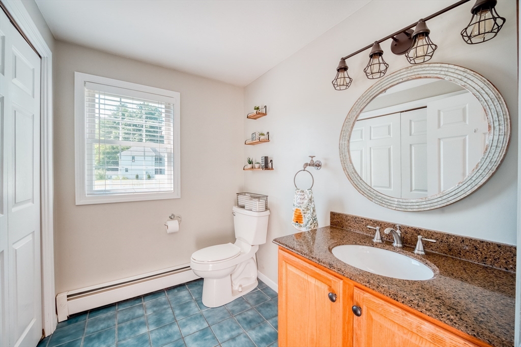46 Brookline Street Pepperell, MA 01463 - Photo 14 of 41 a bathroom with a granite countertop sink and a mirror