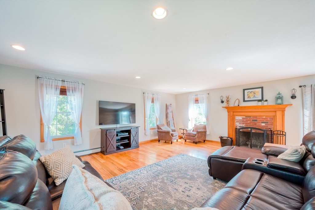 46 Brookline Street Pepperell, MA 01463 - Photo 19 of 41 a living room with furniture and a fireplace