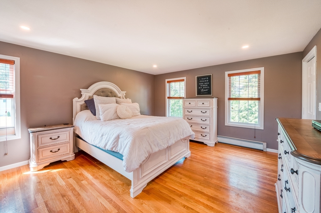 46 Brookline Street Pepperell, MA 01463 - Photo 21 of 41 a spacious bedroom with a bed and wooden floor