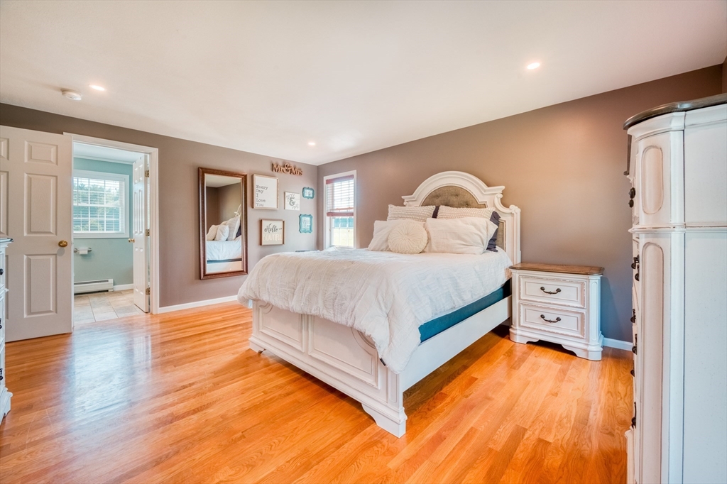 46 Brookline Street Pepperell, MA 01463 - Photo 22 of 41 a bedroom with a bed and wooden floor