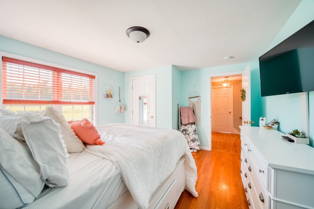 46 Brookline Street Pepperell, MA 01463 - Photo 27 of 41 a bedroom with a bed and flat screen tv