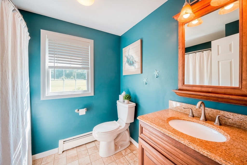 46 Brookline Street Pepperell, MA 01463 - Photo 28 of 41 a bathroom with a granite countertop sink and a mirror