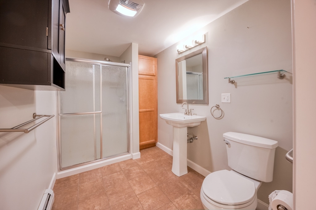 46 Brookline Street Pepperell, MA 01463 - Photo 35 of 41 a white toilet sitting next to a bathroom sink