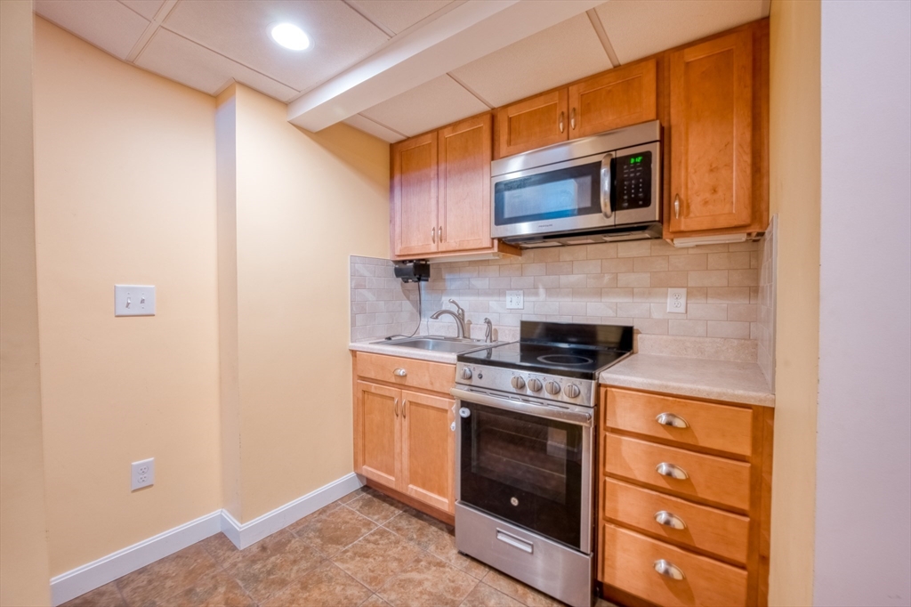 46 Brookline Street Pepperell, MA 01463 - Photo 36 of 41 a kitchen with stainless steel appliances granite countertop a stove and a microwave