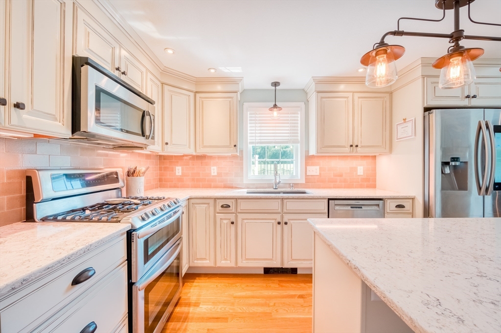 46 Brookline Street Pepperell, MA 01463 - Photo 8 of 41 a kitchen with stainless steel appliances granite countertop a sink stove and refrigerator