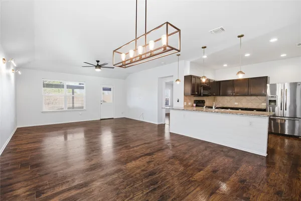 a view of kitchen with wooden floor and electronic appliances