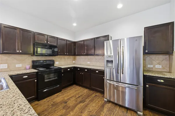 a kitchen with a refrigerator stove and microwave