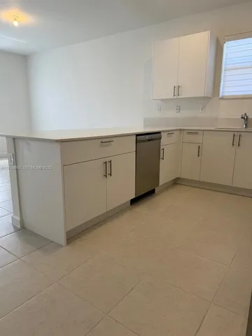 a large kitchen with stainless steel appliances