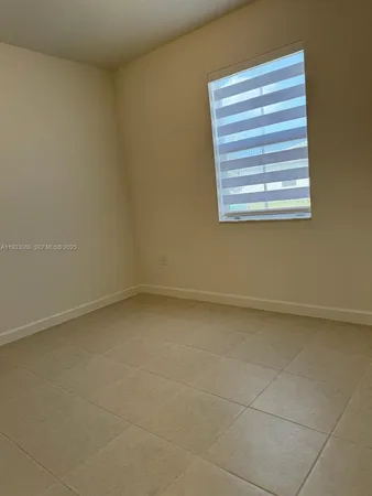 a view of a small space with wooden floor and a window