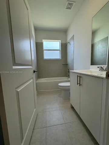 a bathroom with a sink a toilet and bathtub