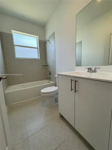 a bathroom with a toilet a sink and bathtub