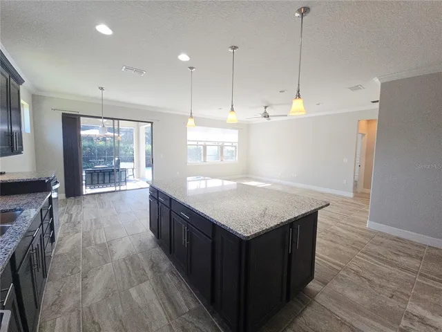 a kitchen with a wooden floor and window
