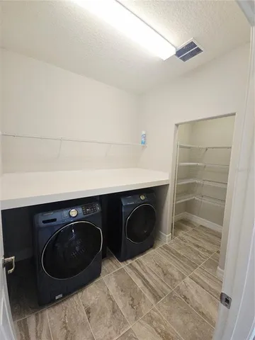 a utility room with washing machine and dryer