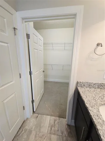 a bathroom with a granite countertop sink and shower