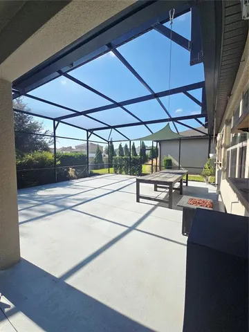 a view of a room with wooden floor and fan