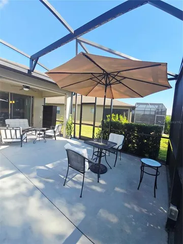 a view of a swimming pool with chairs in patio