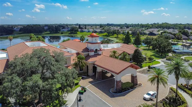 an aerial view of a house with swimming pool and outdoor seating