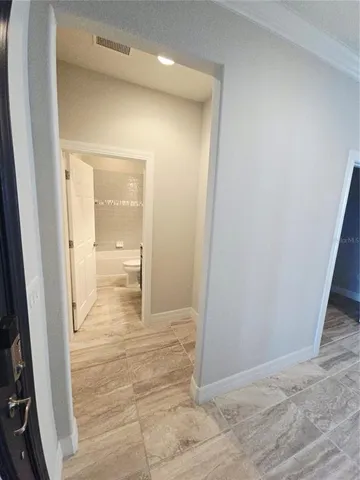 a view of a bathroom from the hallway