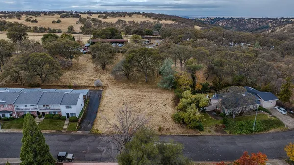 an aerial view of a house with a yard