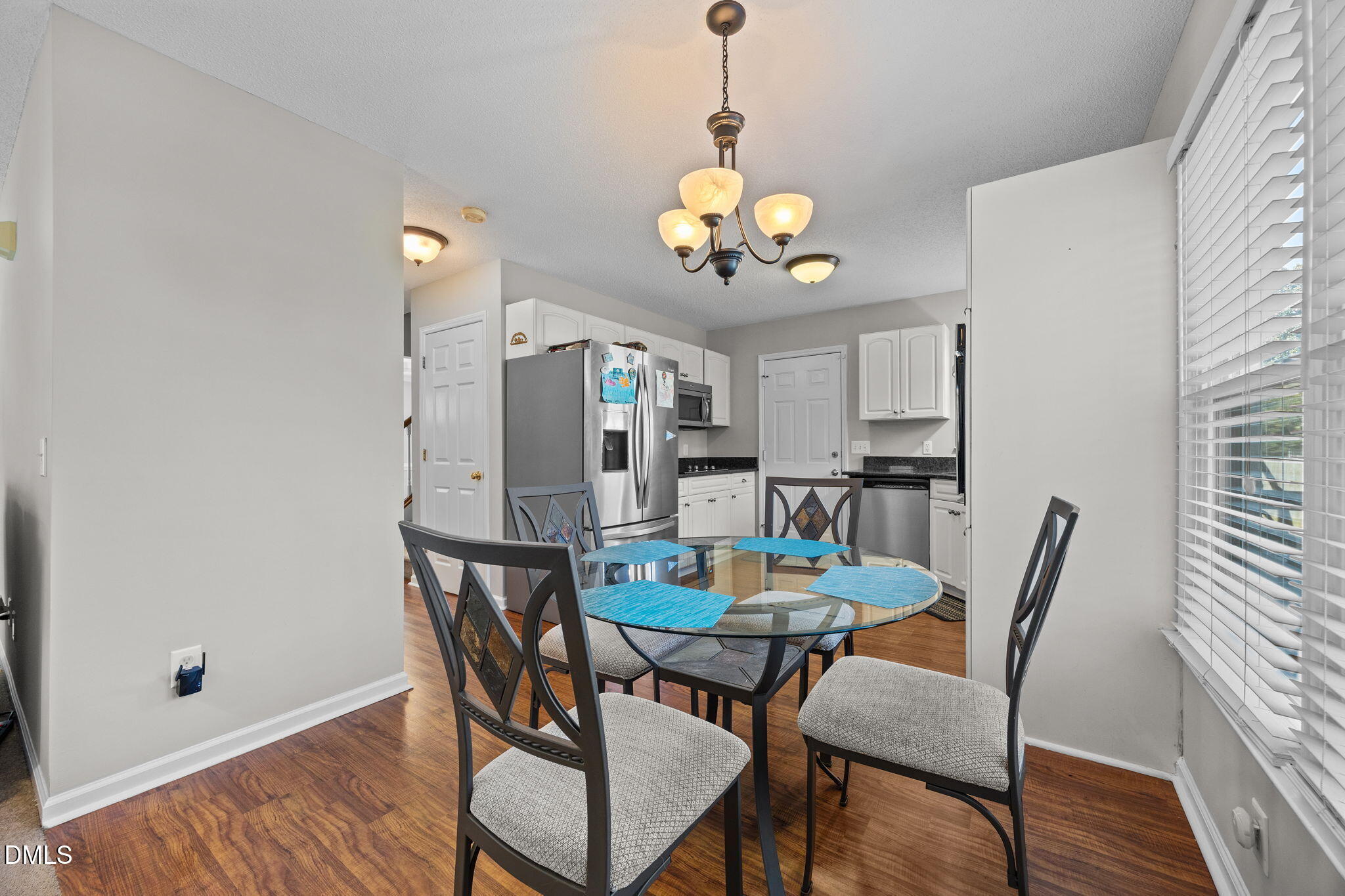30 Stockton Drive Angier, NC 27501 - Photo 19 of 52 a view of a dining room with furniture wooden floor and chandelier