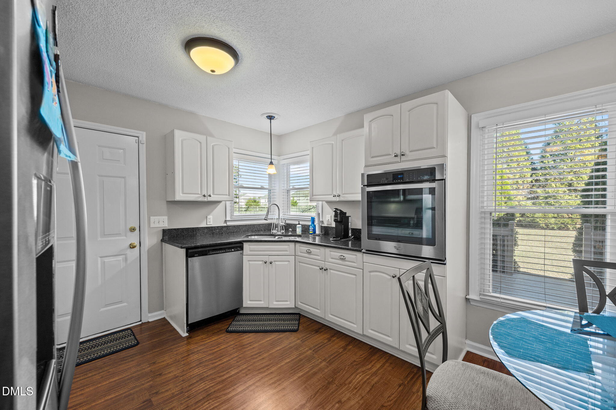 30 Stockton Drive Angier, NC 27501 - Photo 21 of 52 a kitchen with granite countertop a stove a sink and a refrigerator