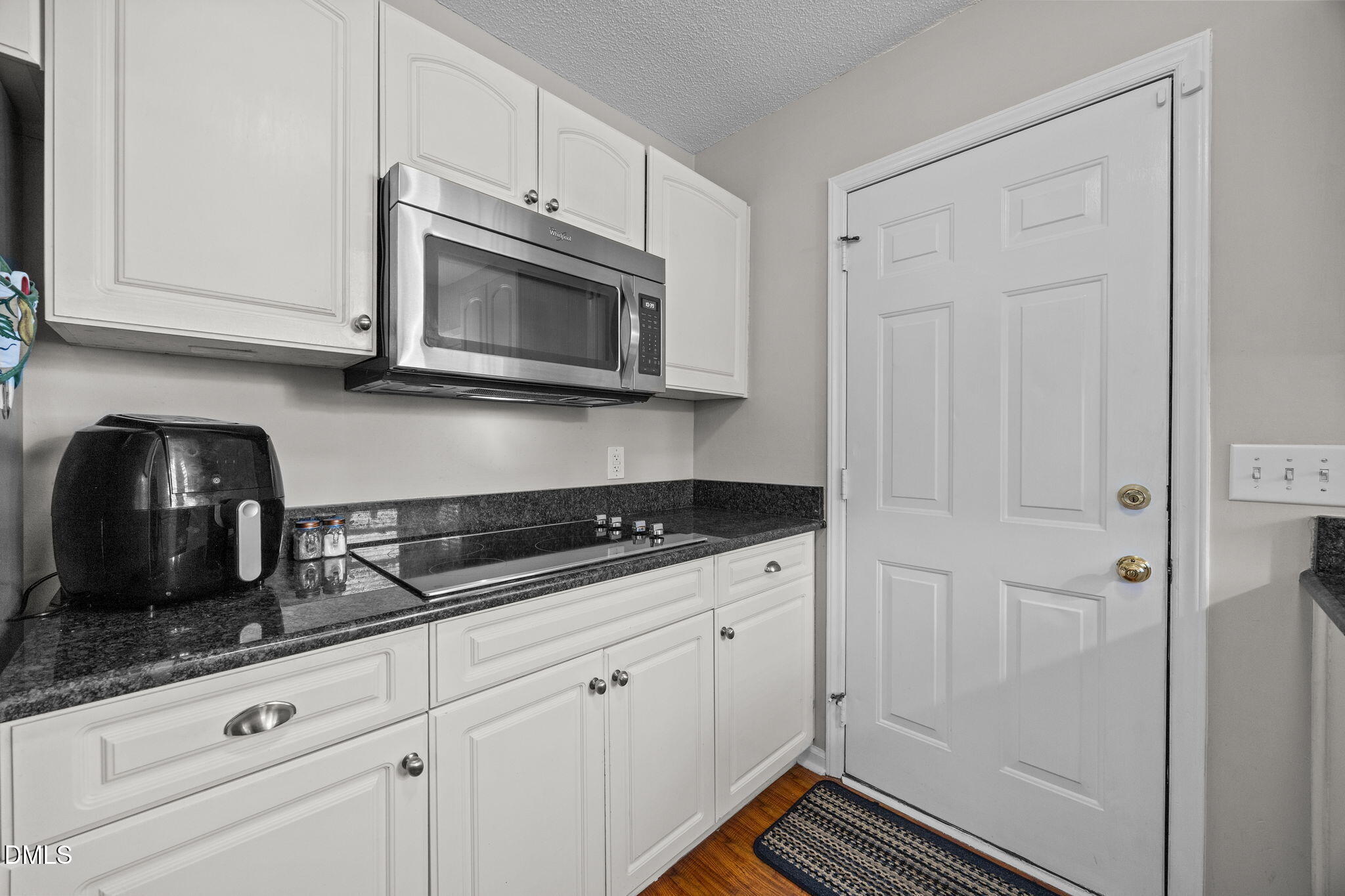 30 Stockton Drive Angier, NC 27501 - Photo 23 of 52 a kitchen with granite countertop white cabinets and stainless steel appliances