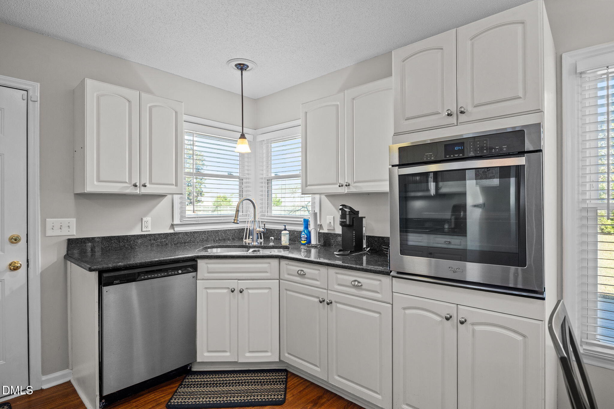 30 Stockton Drive Angier, NC 27501 - Photo 24 of 52 a kitchen with granite countertop white cabinets white stainless steel appliances and a sink