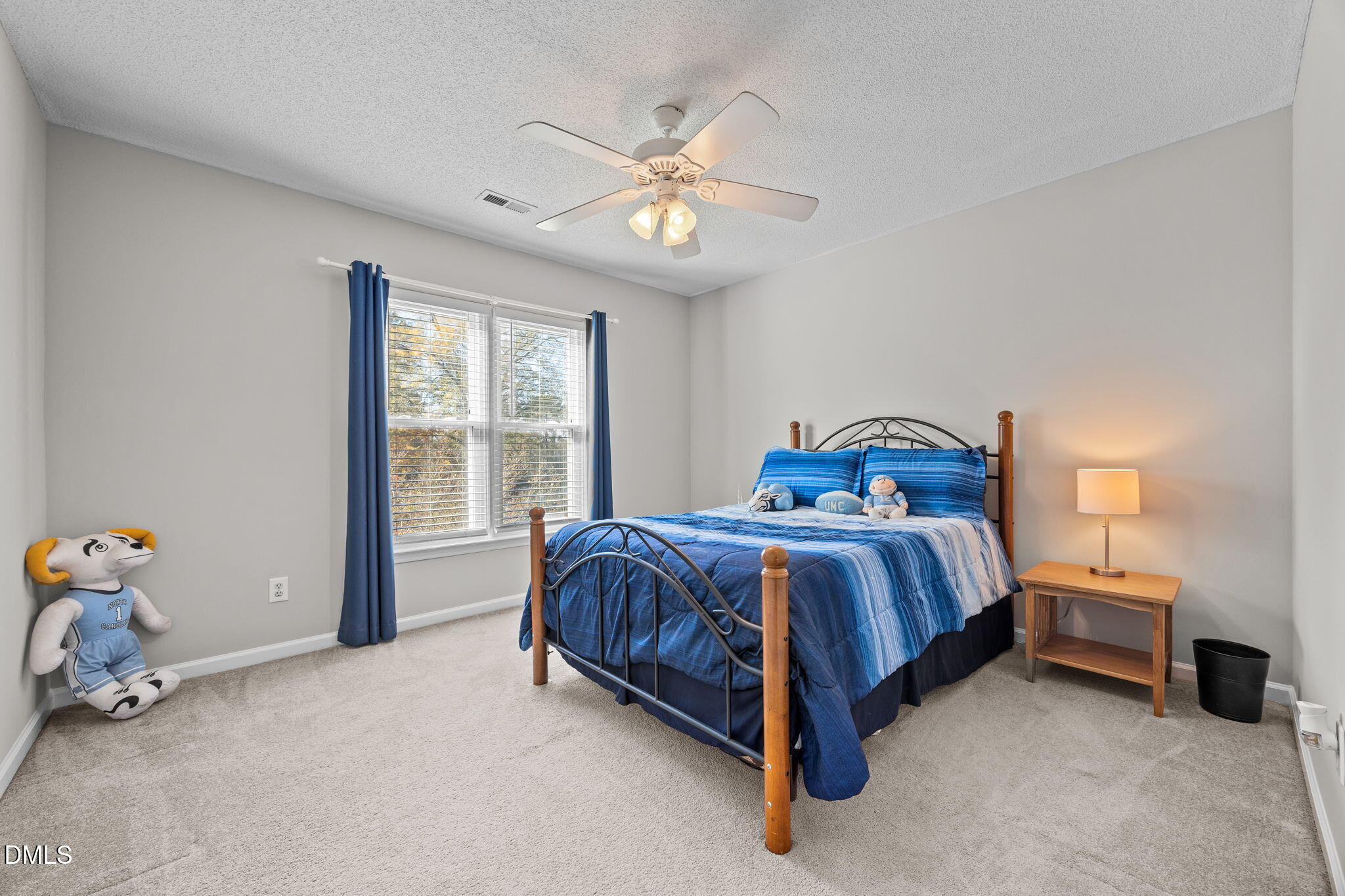 30 Stockton Drive Angier, NC 27501 - Photo 29 of 52 a bedroom with a bed and a chandelier