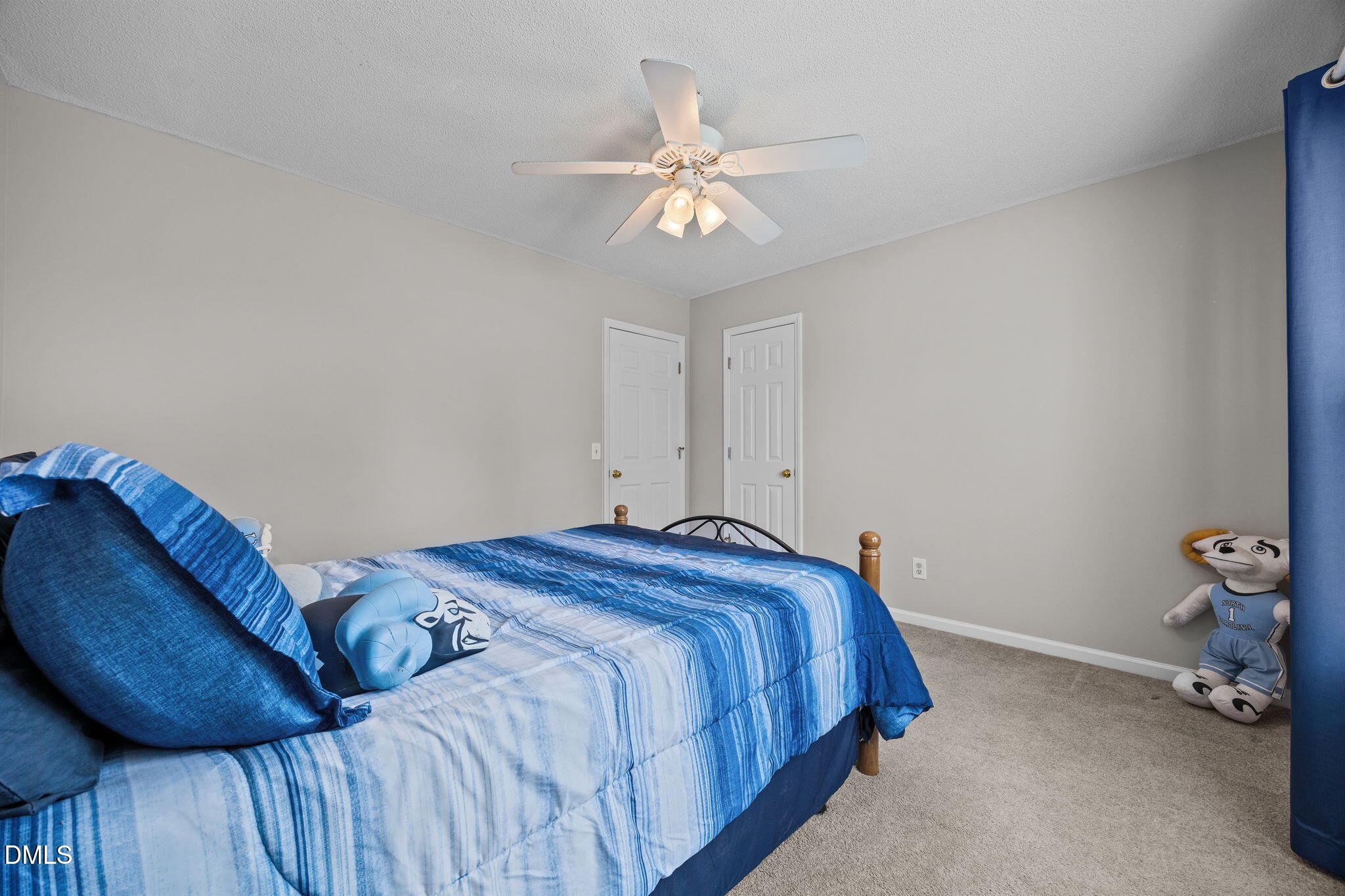 30 Stockton Drive Angier, NC 27501 - Photo 30 of 52 a bedroom with a bed and a chandelier