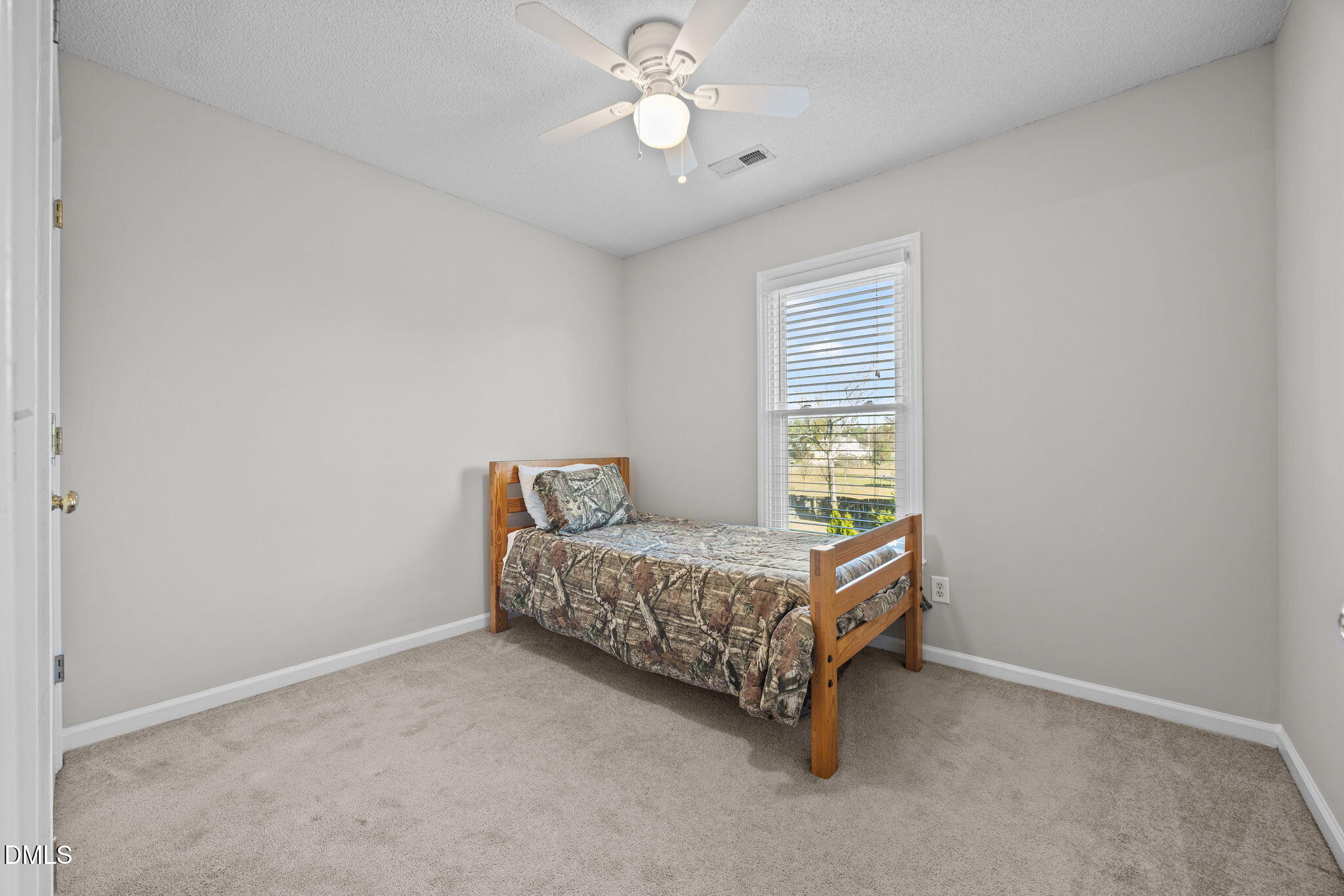 30 Stockton Drive Angier, NC 27501 - Photo 32 of 52 a bedroom with a bed and a ceiling fan