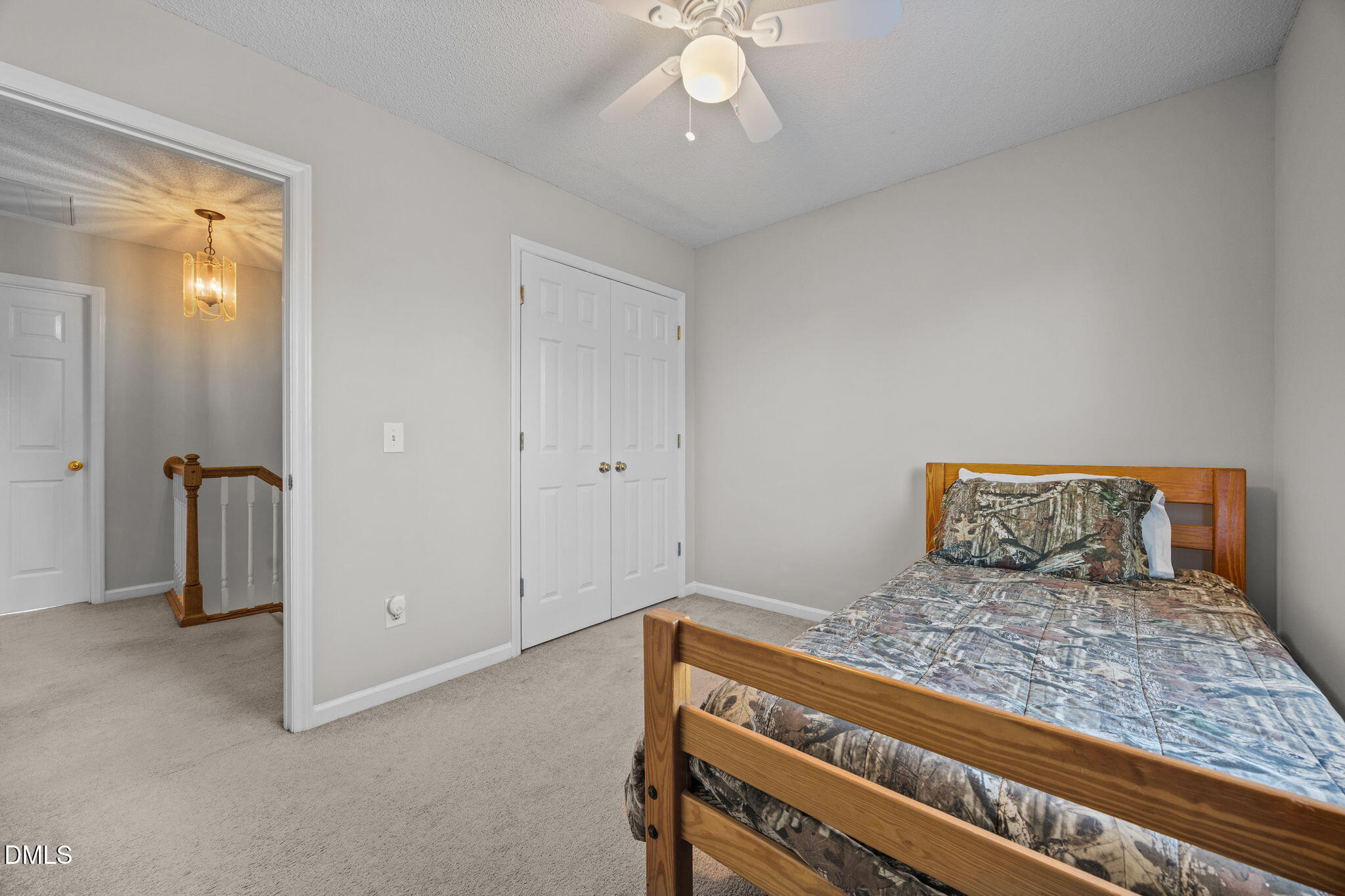 30 Stockton Drive Angier, NC 27501 - Photo 33 of 52 a bedroom with a bed and a chandelier