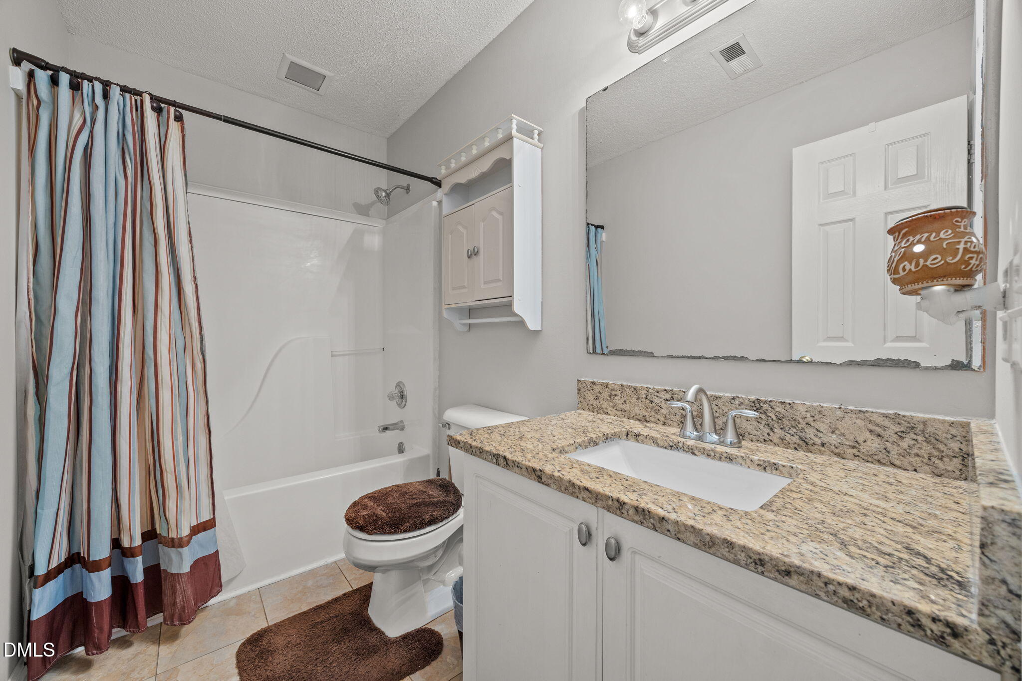 30 Stockton Drive Angier, NC 27501 - Photo 34 of 52 a bathroom with a granite countertop sink a toilet and a mirror