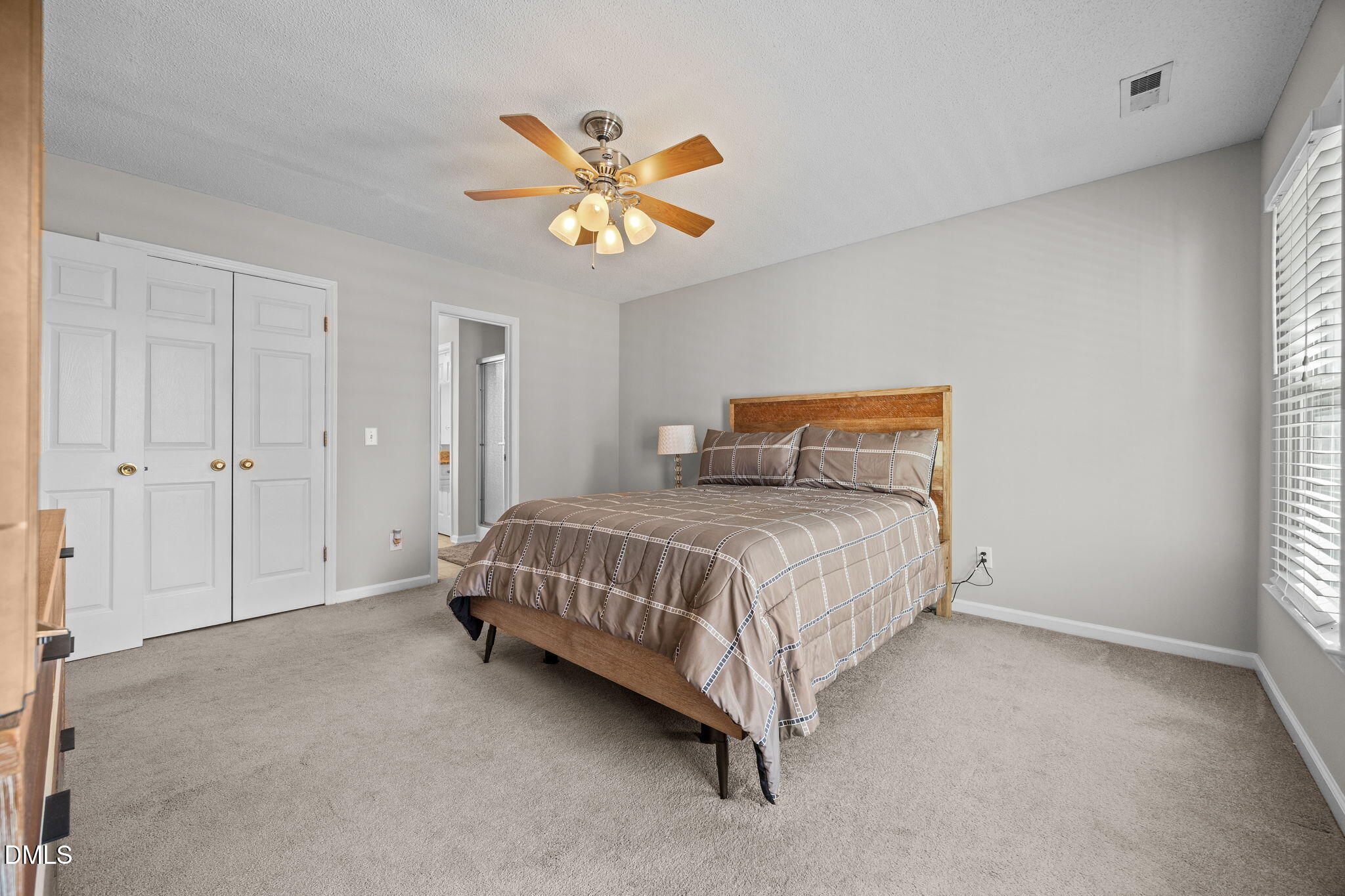 30 Stockton Drive Angier, NC 27501 - Photo 36 of 52 a bedroom with a bed and a chandelier