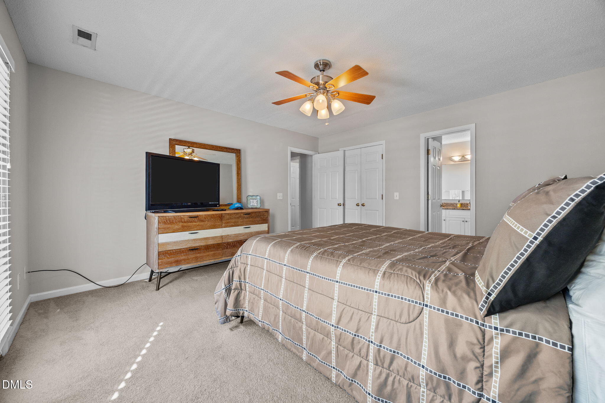 30 Stockton Drive Angier, NC 27501 - Photo 37 of 52 a bedroom with a bed and a flat screen tv