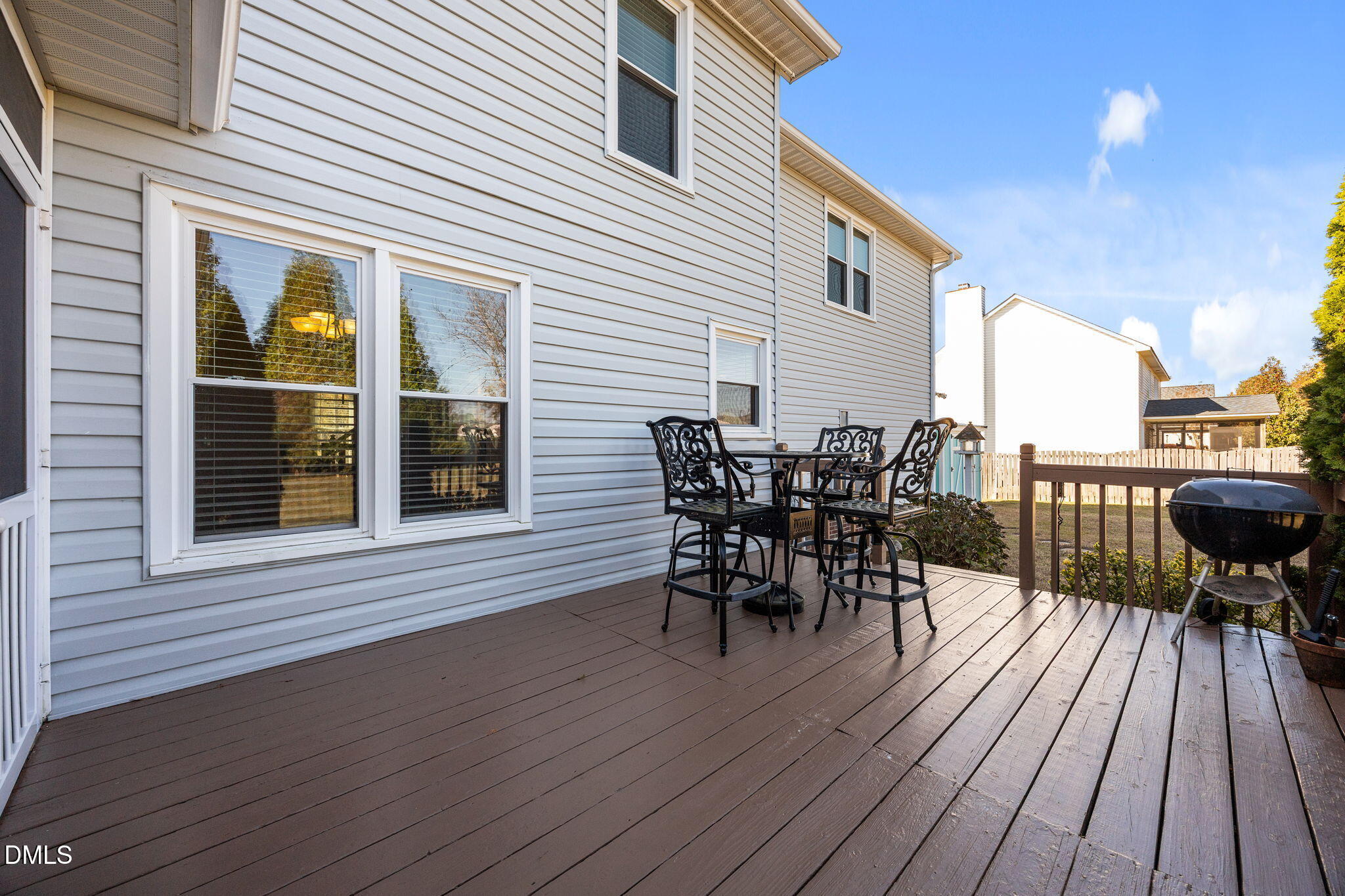 30 Stockton Drive Angier, NC 27501 - Photo 43 of 52 a view of a roof deck with table and chairs floor to ceiling window with wooden floor