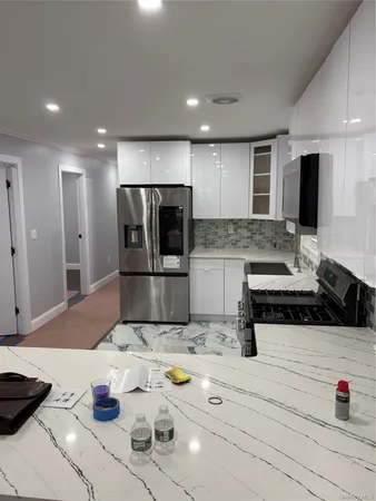 a kitchen with stainless steel appliances kitchen island granite countertop a sink and cabinets