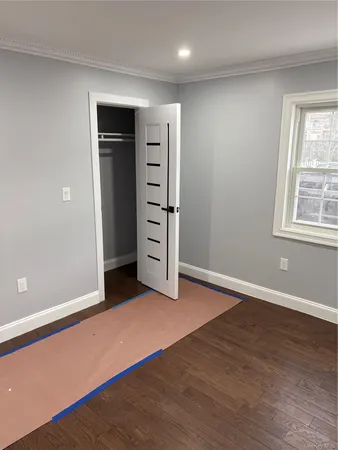 an empty room with windows and closet