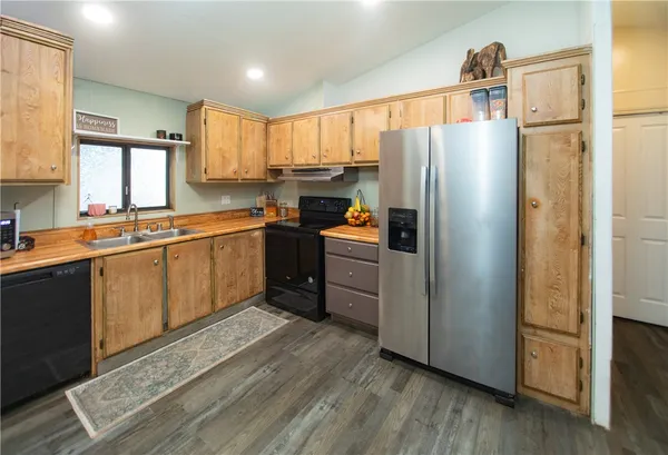 a kitchen with a sink refrigerator and microwave