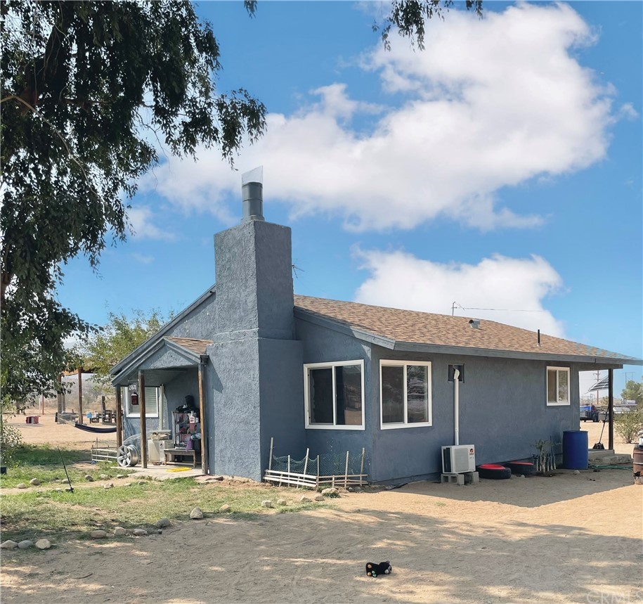 23676 Tussing Ranch Road Apple Valley, CA 92308 - Photo 1 of 1 a front view of a house with a pathway