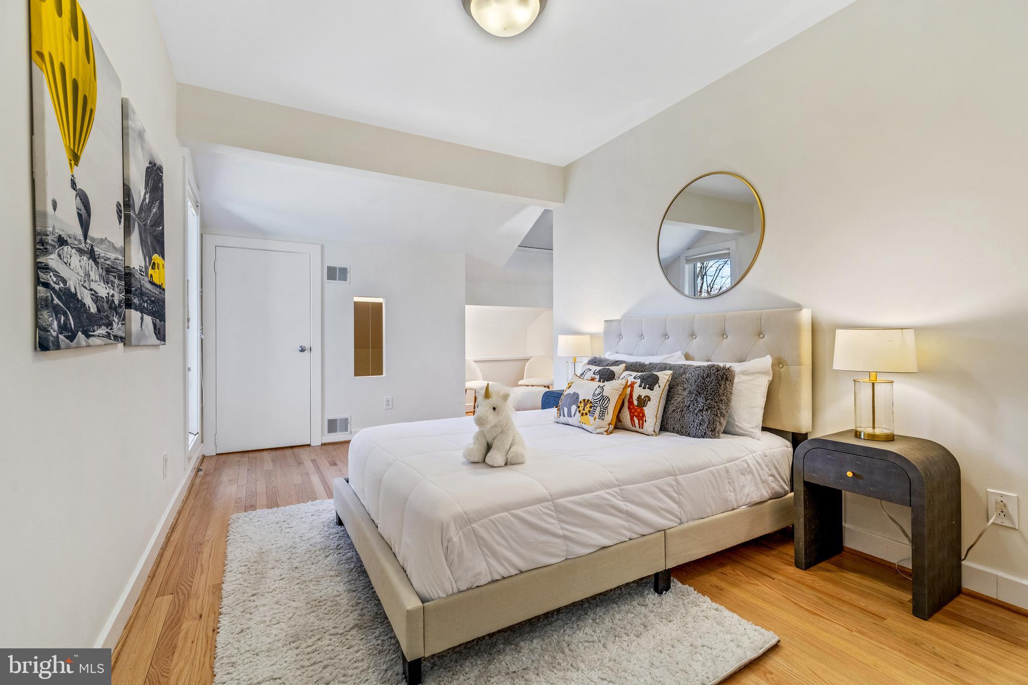 2609 Klingle Road Northwest Washington, DC 20008 - Photo 28 of 41 a bedroom with a bed and wooden floor