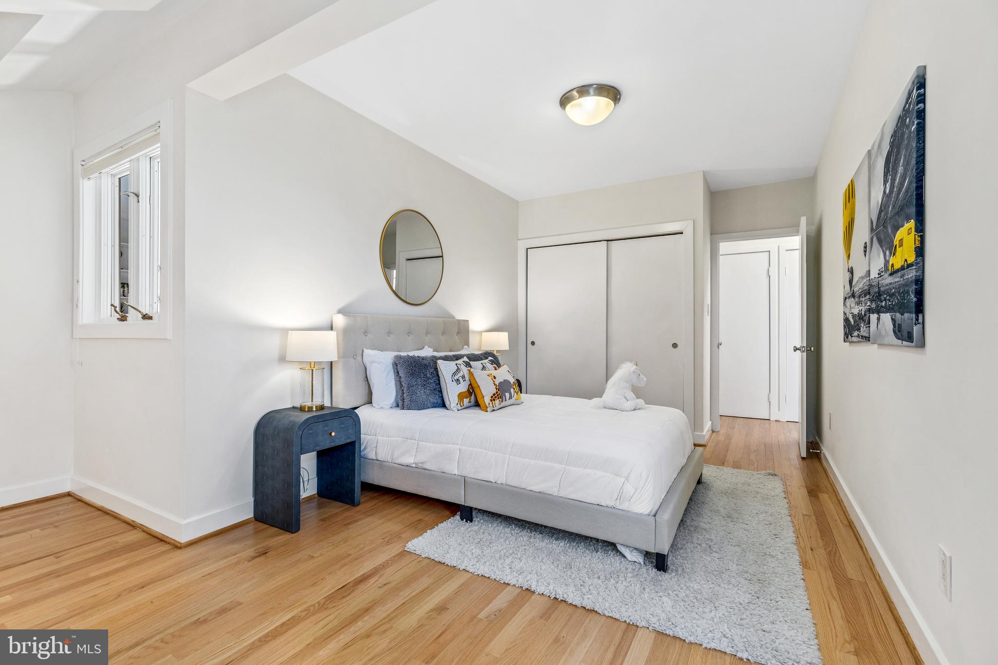 2609 Klingle Road Northwest Washington, DC 20008 - Photo 29 of 41 a bedroom with a bed and wooden floor