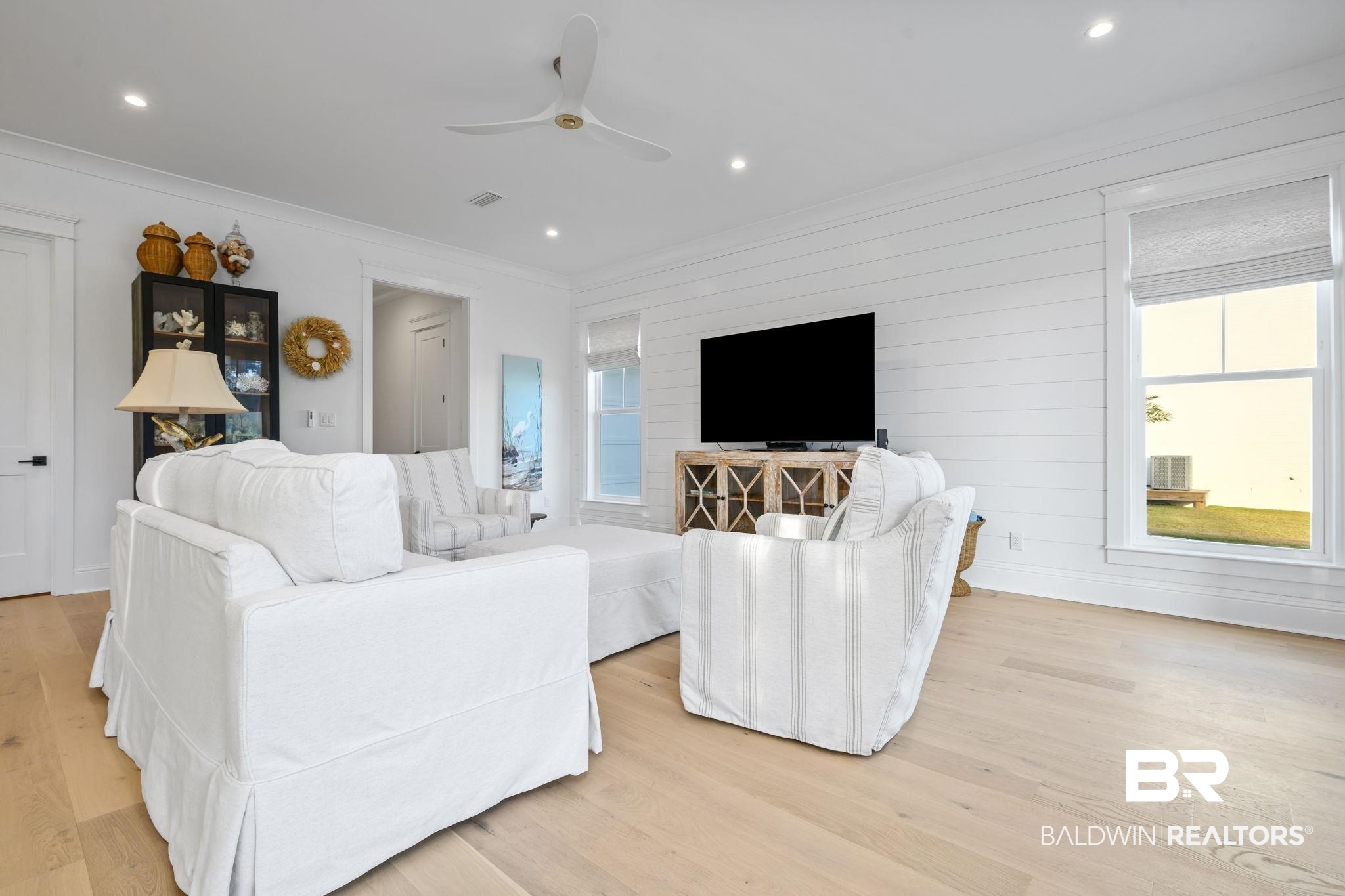30313 River Road Orange Beach, AL 36561 - Photo 18 of 50 Living room with light wood finished floors, a ceiling fan, crown molding, and recessed lighting