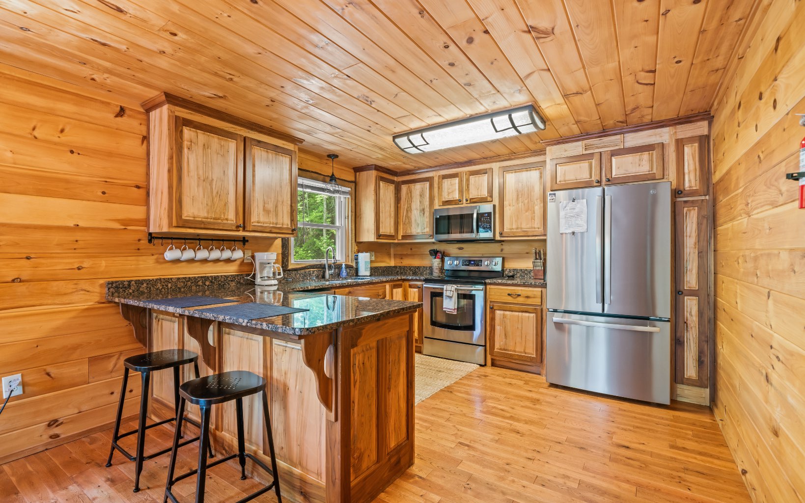 285 Shallowford Bridge Lane Blue Ridge, GA 30513 - Photo 17 of 66 a kitchen with stainless steel appliances granite countertop a refrigerator a sink dishwasher a stove and white countertops with wooden floor